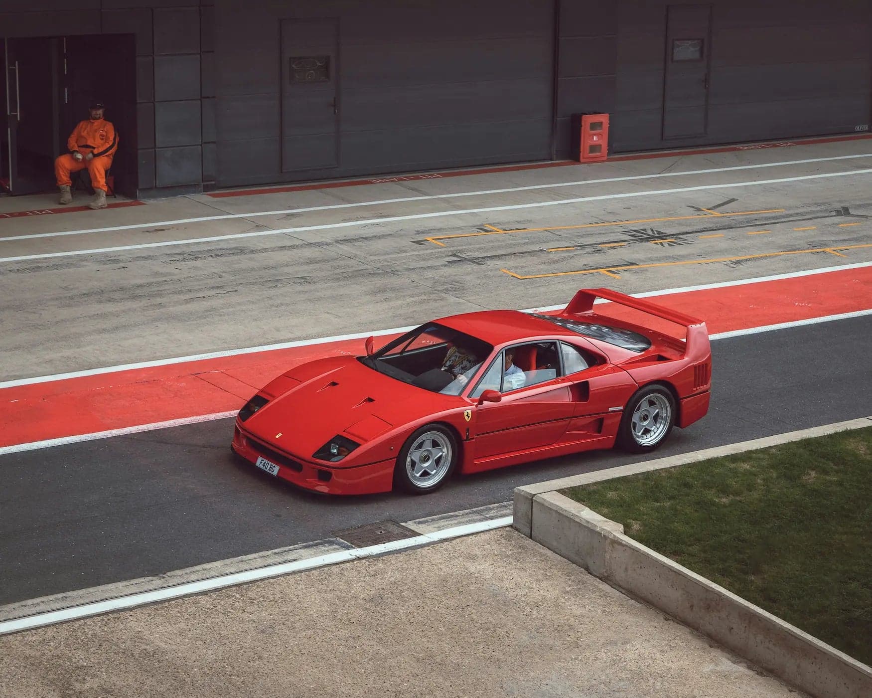 Red Ferrari F40 in a racetrack pit lane
