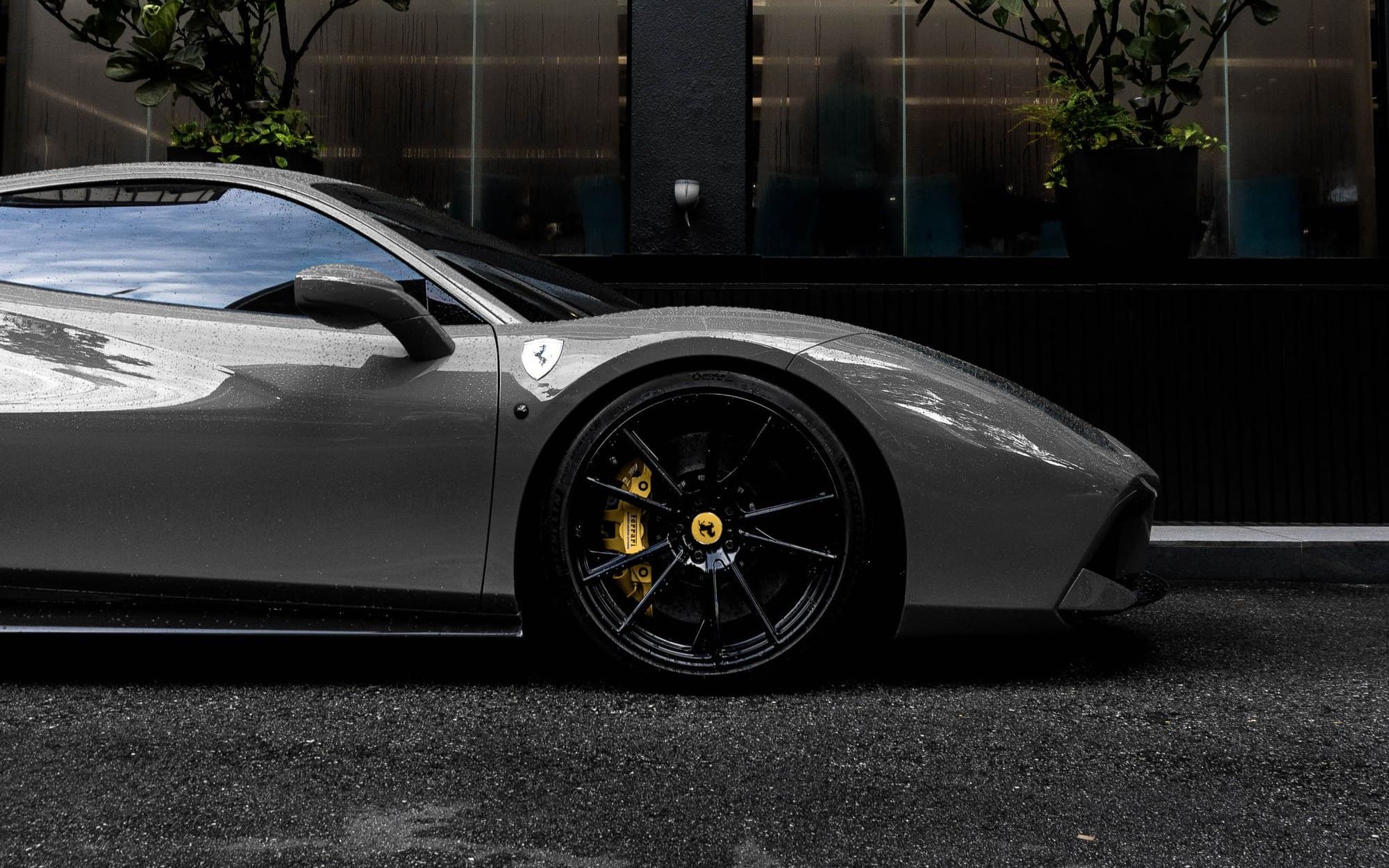 Grey Ferrari 488 GTB parked on a dark city street