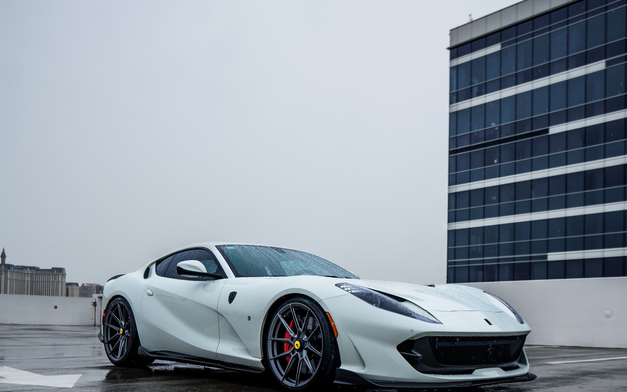 White Ferrari 812 Superfast on a wet Las Vegas rooftop