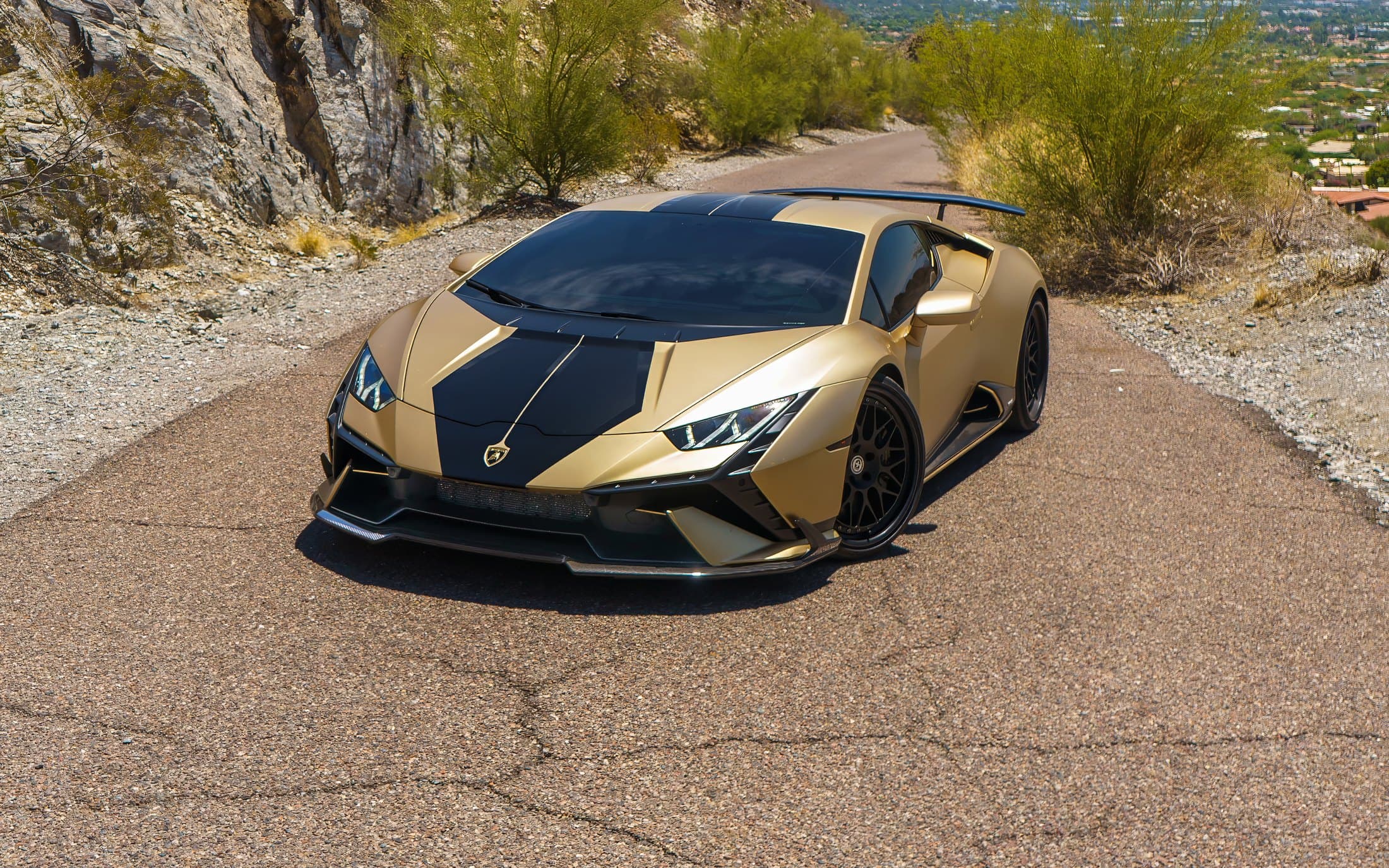 Gold Lamborghini Huracán Performante on a desert mountain road