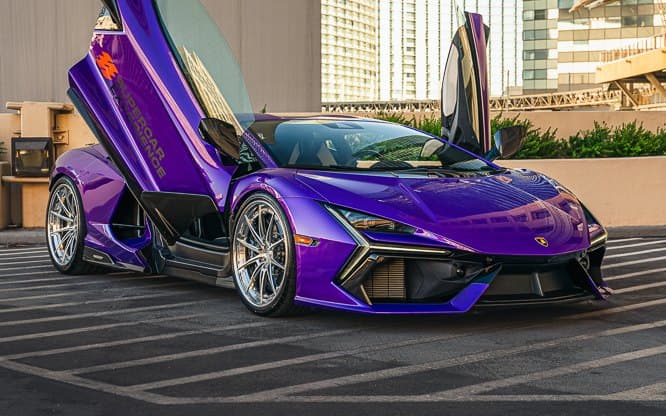 Purple Lamborghini Revuelto with its doors raised on a Las Vegas rooftop