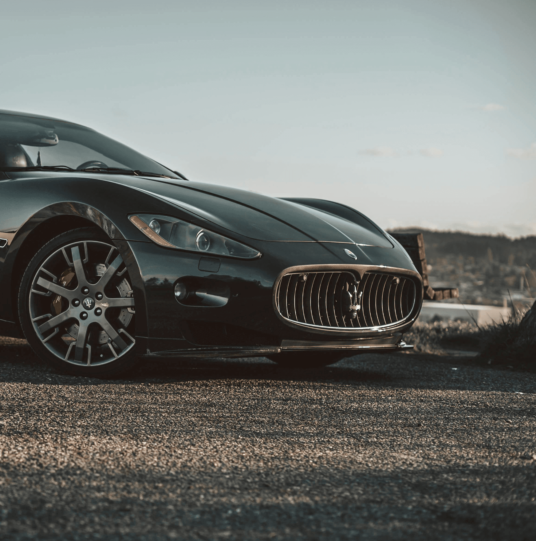 Black Maserati GranTurismo front end at golden hour