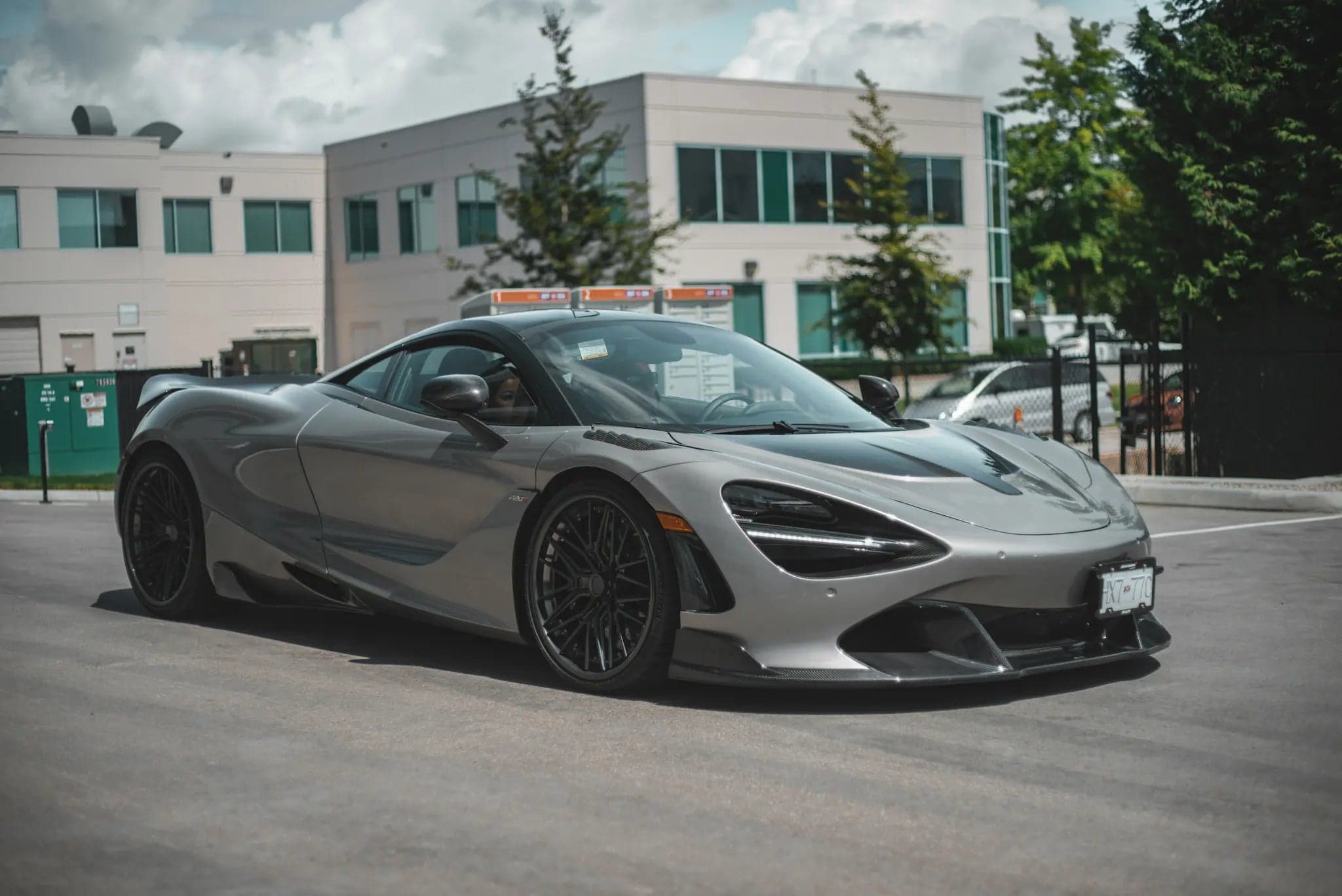 Gray McLaren 720S parked outside a modern building