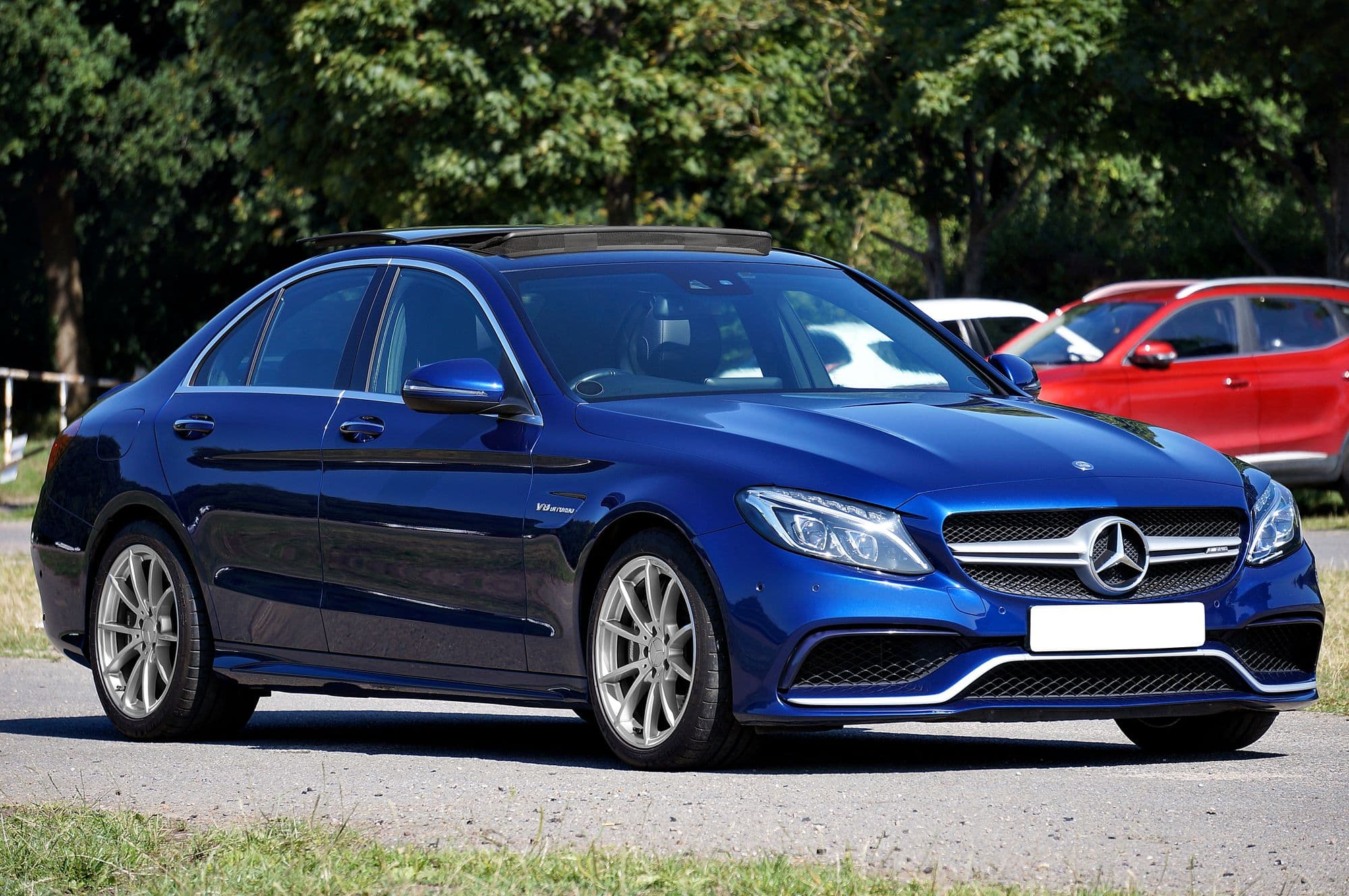 Blue Mercedes-AMG C63 sedan parked outdoors on a sunny day