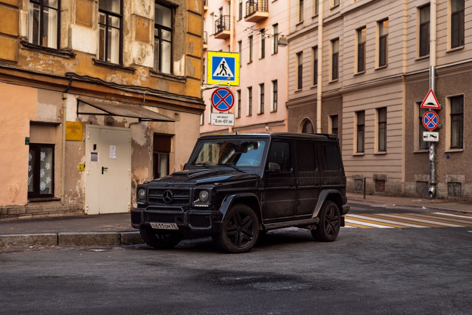 Black Mercedes-AMG G-Class parked on a historic city street