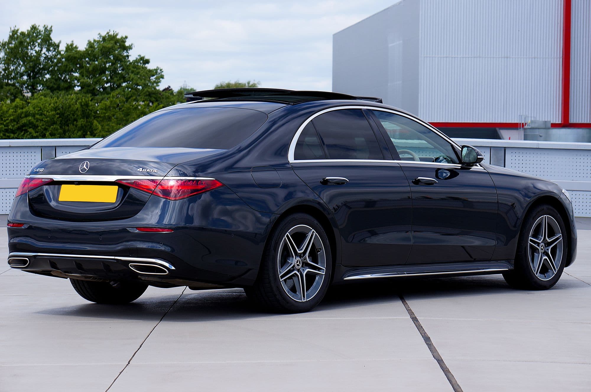 Dark blue Mercedes-Benz S-Class sedan parked on a rooftop deck