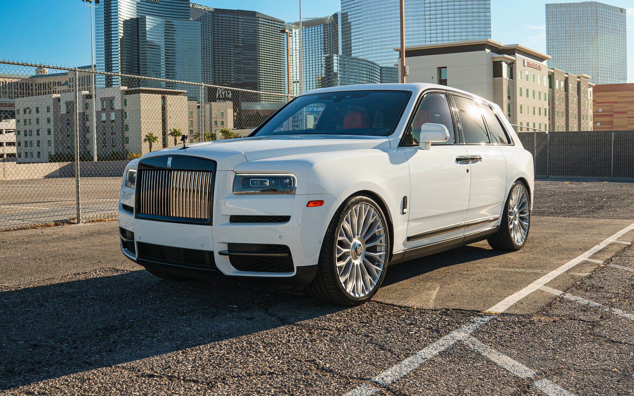 White Rolls-Royce Cullinan with the Las Vegas skyline behind it