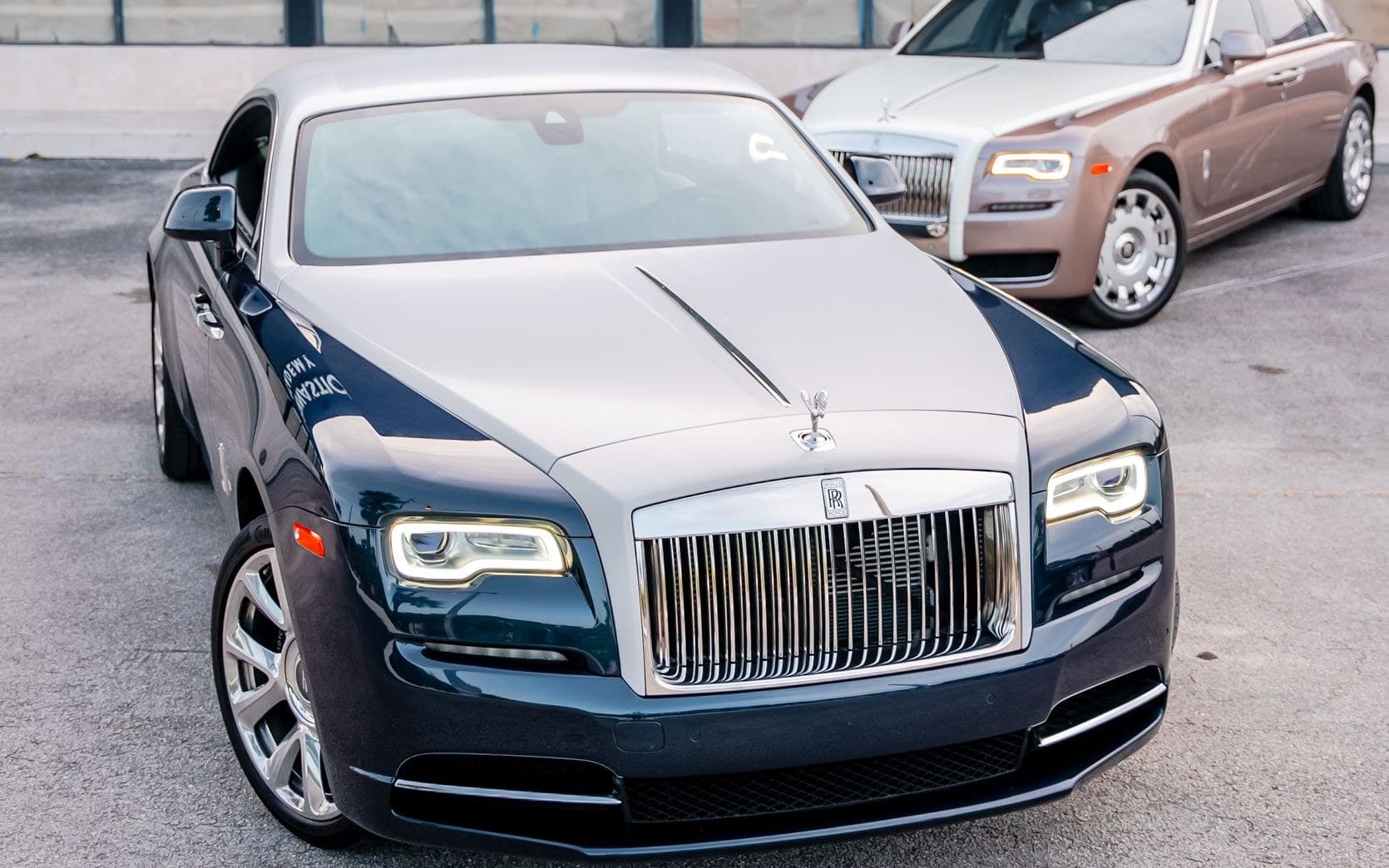Two-tone blue Rolls-Royce Wraith parked outside a modern building