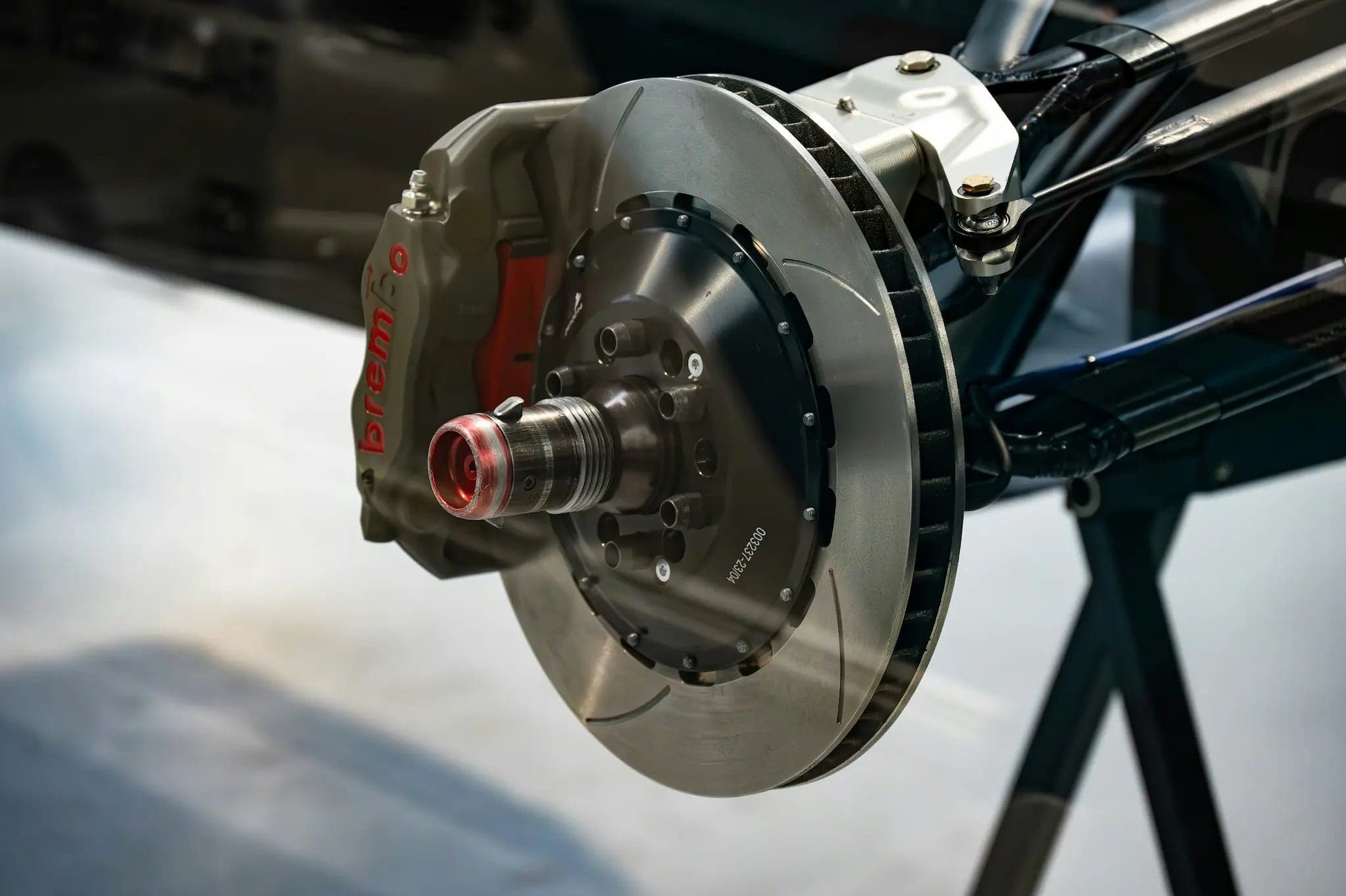 Brembo brake caliper and slotted rotor assembly on a hub