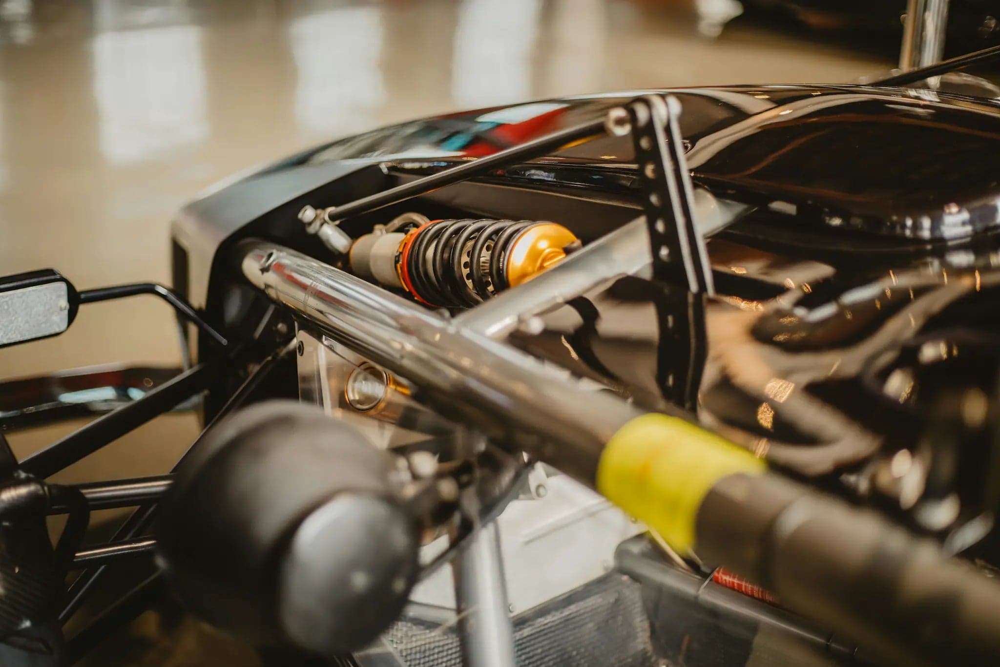 Gold coilover suspension damper mounted on a race car chassis